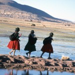 Girls spinning as they walk along Lake Titicaca. 